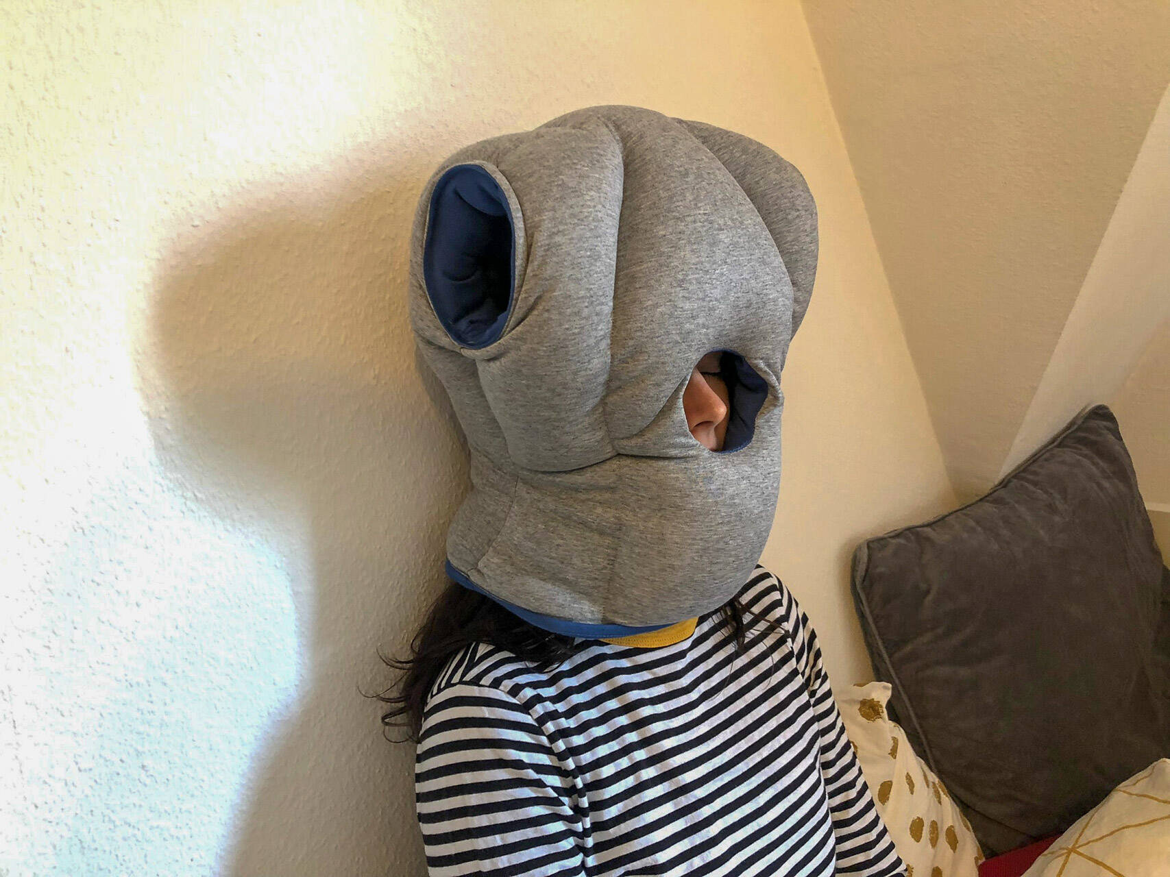 ostrichpillow original napping pillow napping against wall